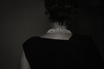 Rear view of woman wearing necklace