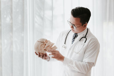 Doctor holding human skull