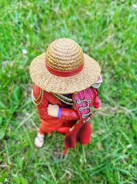 Rear view of woman wearing hat on field