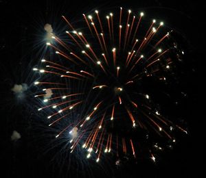 Low angle view of firework display at night