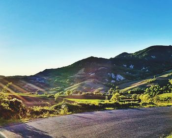 Scenic view of mountains against clear blue sky