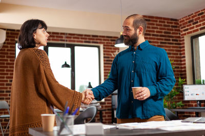 Businessman shaking hand with colleague