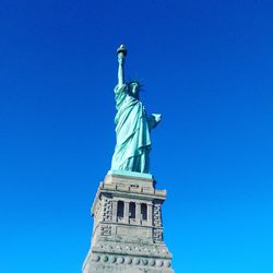 Low angle view of statue against blue sky