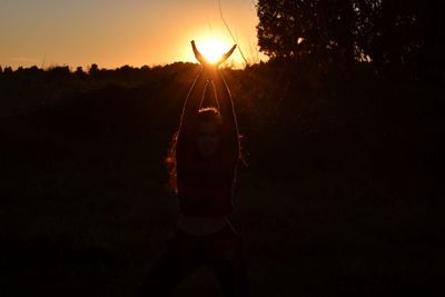 Silhouette man against sky during sunset