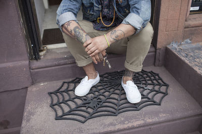 A young man on a doorstep.