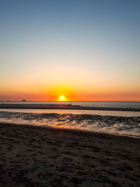 Scenic view of sea against clear sky during sunset