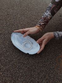 Low section of woman standing on sand