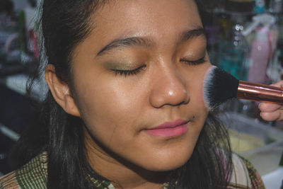 Close-up portrait of woman with eyes closed