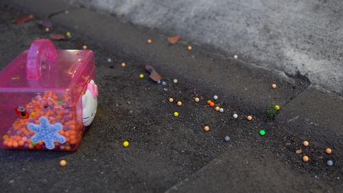 Close-up of multi colored stones on road in city