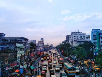 High angle view of busy street amidst buildings in city against sky.