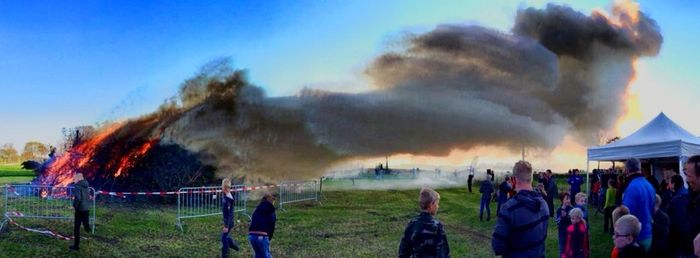 View of field against cloudy sky