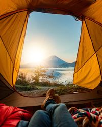 Low section of man at tent against sky