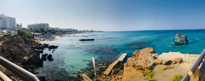 High angle view of city by sea against sky