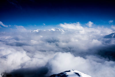 Scenic view of mountains against cloudy sky