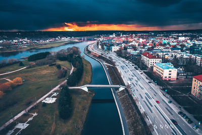 Aerial view of city street against sky during sunset