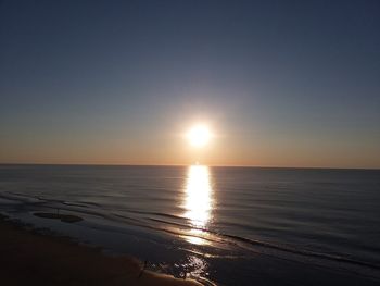 Scenic view of sea against clear sky during sunset