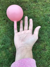 Close-up of hand holding balloons