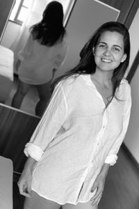 Portrait of a smiling young woman sitting at home