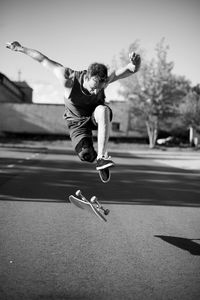 Full length of man jumping on skateboard