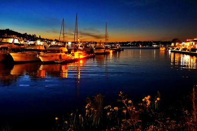 Boats in harbor at night