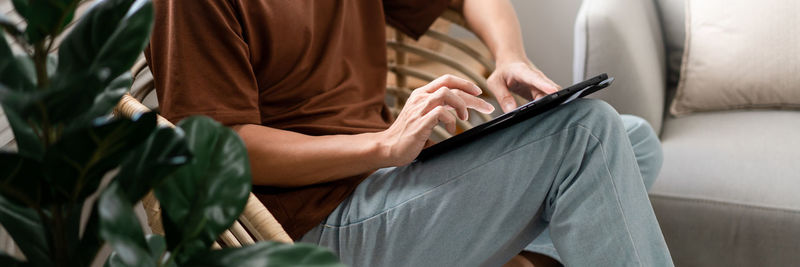 Midsection of woman using laptop