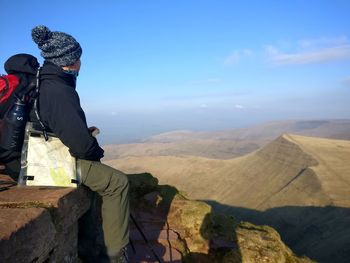 People on mountain against sky