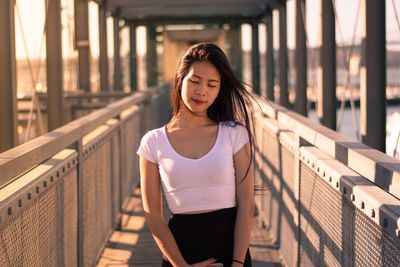 Portrait of young woman on bridge