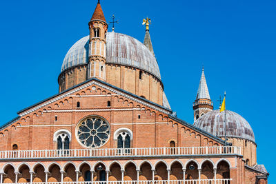 Low angle view of historical building against clear blue sky