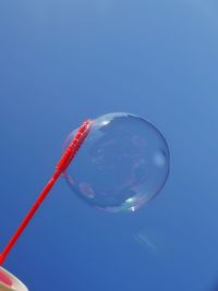 Close-up of soapbubble  against blue sky