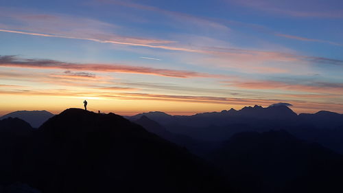 Scenic view of silhouette mountains against sky during sunset