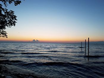 Scenic view of sea against clear sky during sunset