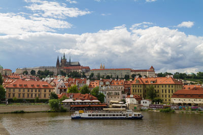 View of cityscape against cloudy sky