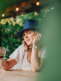 Portrait of a smiling young woman sitting outdoors