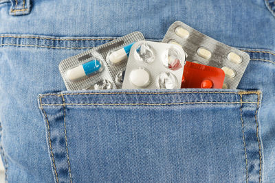 Close-up of medicines in back pocket of jeans