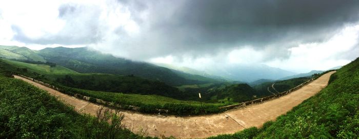 Panoramic view of agricultural landscape against sky