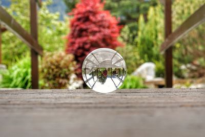 Close-up of crystal ball on wooden table