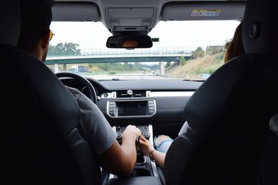 Rear view of couple in car on road trip