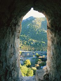 Scenic view of mountains seen through cave