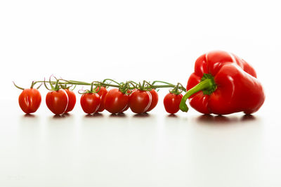 Close-up of red bell peppers against white background