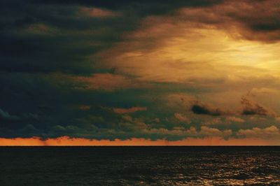 Scenic view of sea against dramatic sky