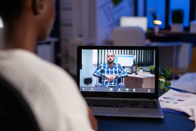 Woman having discussion with colleague on video call