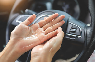 Cropped hand of person holding car