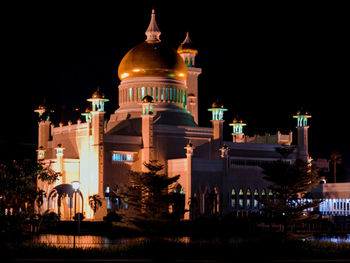 Illuminated building against sky at night