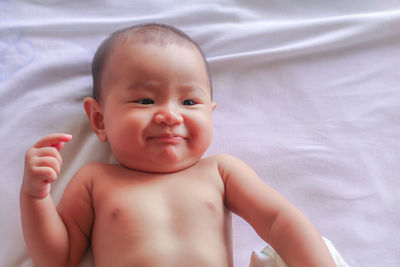 Cute baby girl lying on bed