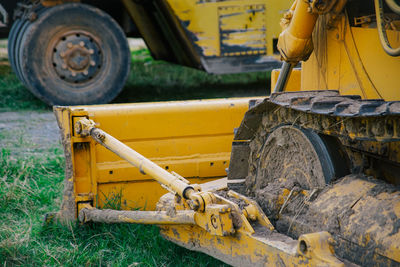 Close-up of earth mover on field