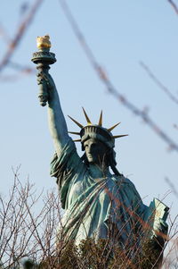 Low angle view of bird statue against sky