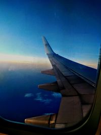 Cropped image of airplane flying over sea