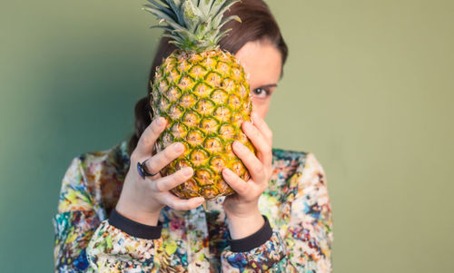 Midsection of woman holding fruit