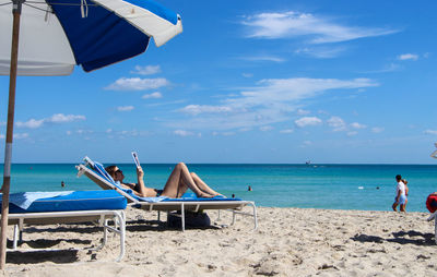 Woman sun bathing at miami beach 