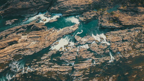 Aerial view of blue water streams at sopheakmit waterfall, cambodia.